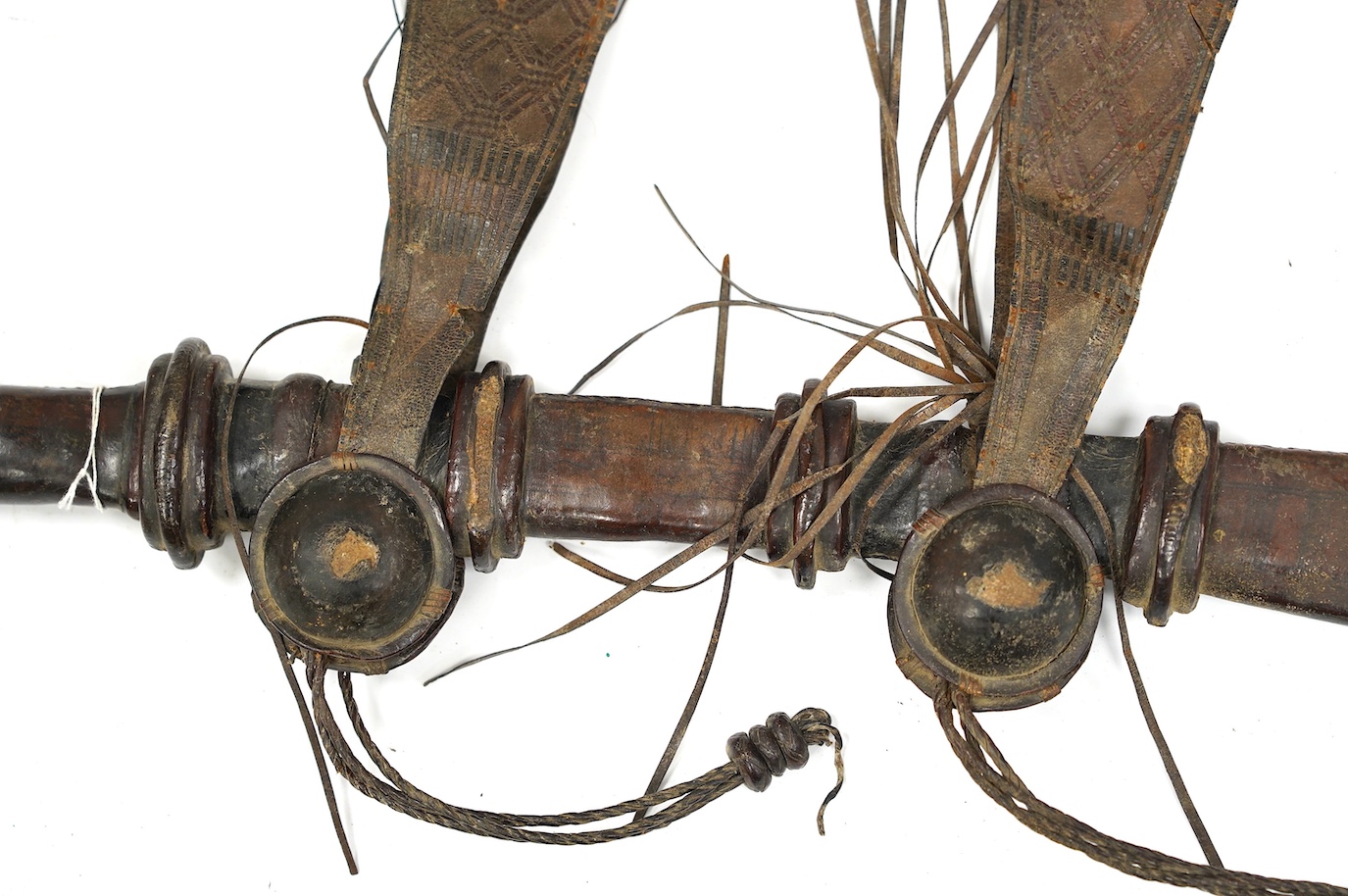 A late 19th century Nigerian Taboura from the Hausa People of Northern Nigeria, in leather scabbard, blade 55.5cm. Condition - good